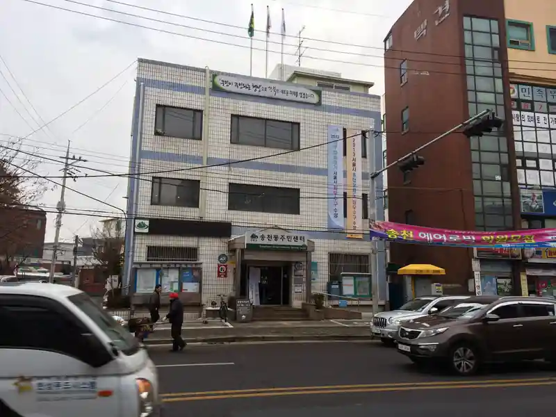 송천동 주민센터 앞 도로와 주변 상가의 과거 모습